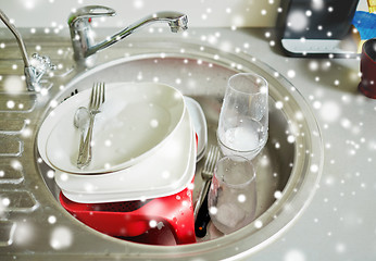 Image showing close up of dirty dishes washing in kitchen sink