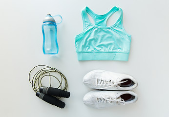 Image showing close up of sportswear, skipping rope and bottle