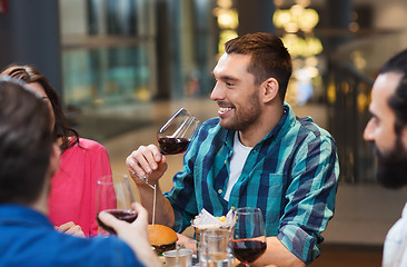 Image showing friends dining and drinking wine at restaurant