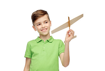 Image showing happy boy in green polo t-shirt with toy airplane