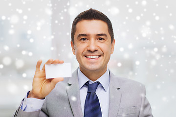 Image showing smiling businessman in suit showing visiting card