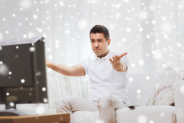 Image showing disappointed man watching tv at home