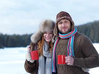 Image showing happy young couple drink warm tea at winter