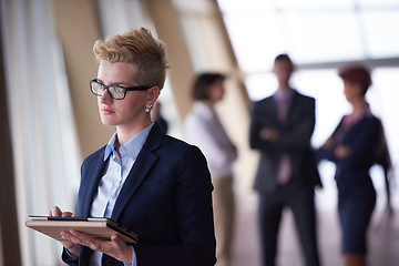 Image showing business woman  at office with tablet  in front  as team leader