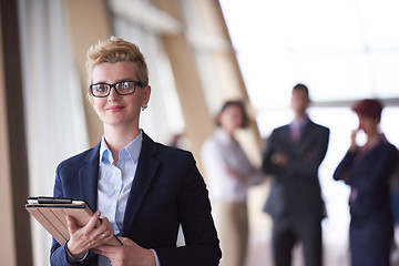 Image showing business woman  at office with tablet  in front  as team leader