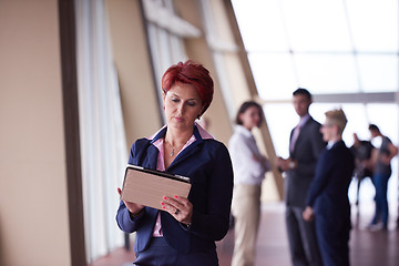 Image showing business woman  at office with tablet  in front  as team leader