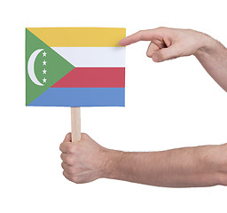 Image showing Hand holding small card - Flag of Comoros