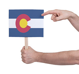 Image showing Hand holding small card - Flag of Colorado