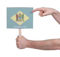 Image showing Hand holding small card - Flag of Delaware