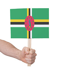 Image showing Hand holding small card - Flag of Dominica