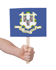 Image showing Hand holding small card - Flag of Connecticut