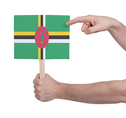 Image showing Hand holding small card - Flag of Dominica