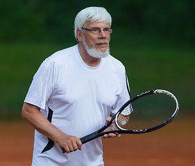 Image showing Senior man playing tennis