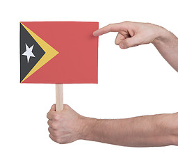 Image showing Hand holding small card - Flag of East Timor