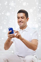 Image showing happy man with smartphone at home