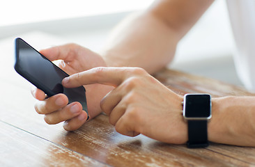 Image showing close up of hands with smart phone and watch