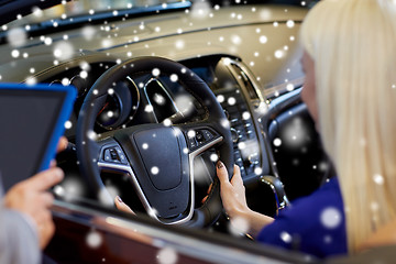 Image showing woman and car dealer with tablet pc in auto salon