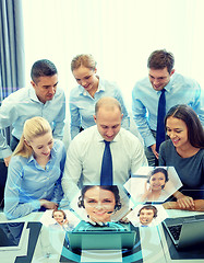 Image showing smiling business people with laptop in office