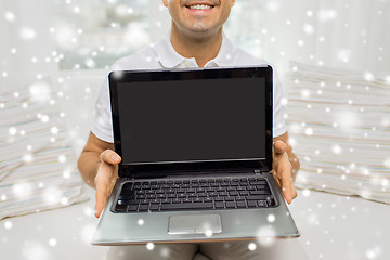 Image showing close up of happy man showing laptop at home