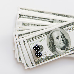 Image showing close up of black dice and usa dollar money