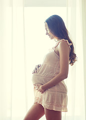 Image showing happy pregnant woman with big bare tummy at home