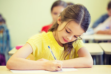 Image showing group of school kids writing test in classroom