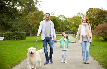 Image showing happy family with labrador retriever dog in park