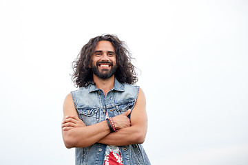 Image showing smiling young hippie man in demin vest