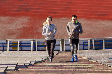 Image showing couple running upstairs on stadium