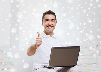 Image showing happy man working with laptop computer at home