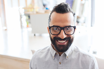 Image showing smiling man with eyeglasses and beard at office