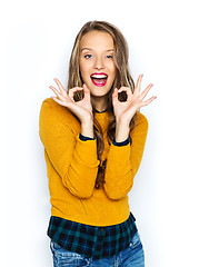 Image showing happy young woman or teen showing ok hand sign