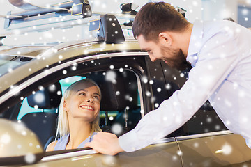 Image showing happy couple buying car in auto show or salon