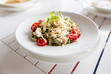 Image showing close up of pasta with tomato and cheese on plate