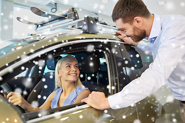 Image showing happy couple buying car in auto show or salon