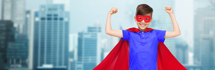 Image showing boy in red super hero cape and mask showing fists