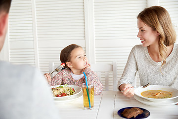 Image showing happy family having dinner at restaurant or cafe