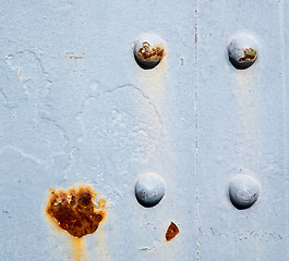 Image showing blue   handle in london antique  door  rusty  brass nail and lig