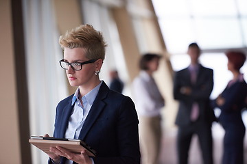 Image showing business woman  at office with tablet  in front  as team leader