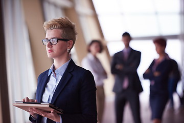 Image showing business woman  at office with tablet  in front  as team leader