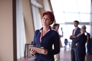 Image showing business woman  at office with tablet  in front  as team leader