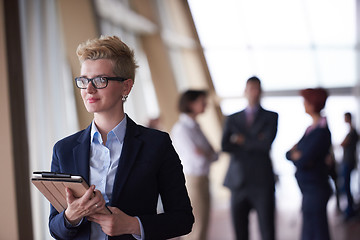 Image showing business woman  at office with tablet  in front  as team leader