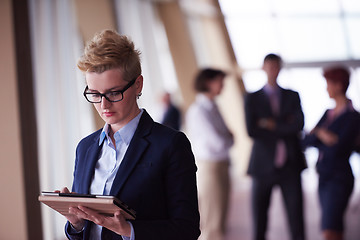 Image showing business woman  at office with tablet  in front  as team leader