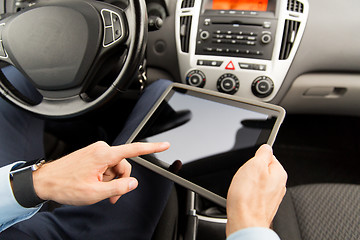 Image showing close up of young man with tablet pc driving car