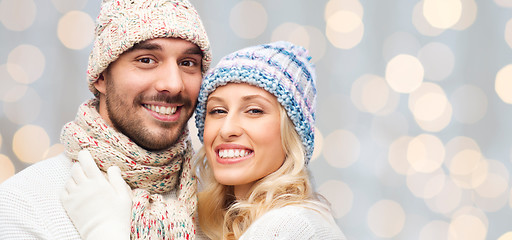 Image showing smiling couple in winter clothes hugging