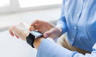 Image showing close up of hands setting smart watch