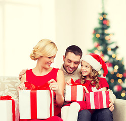 Image showing happy family opening gift boxes