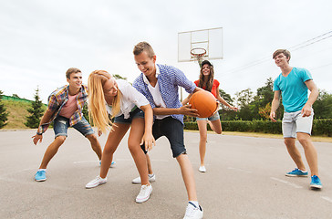 Image showing group of happy teenagers playing basketball