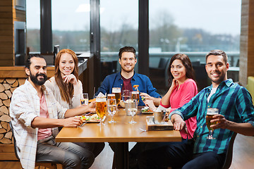 Image showing friends dining and drinking beer at restaurant