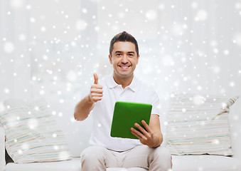 Image showing smiling man working with tablet pc at home